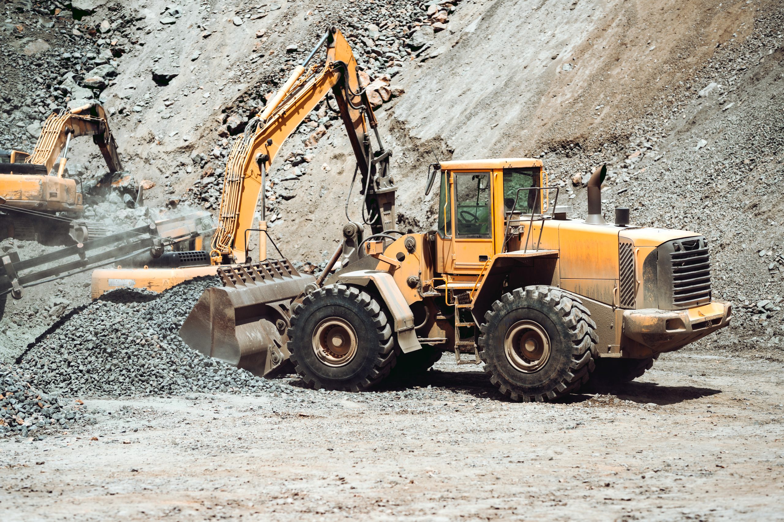 heavy construction machinery in mine - wheel loader transports gravel in a gravel sorting plant