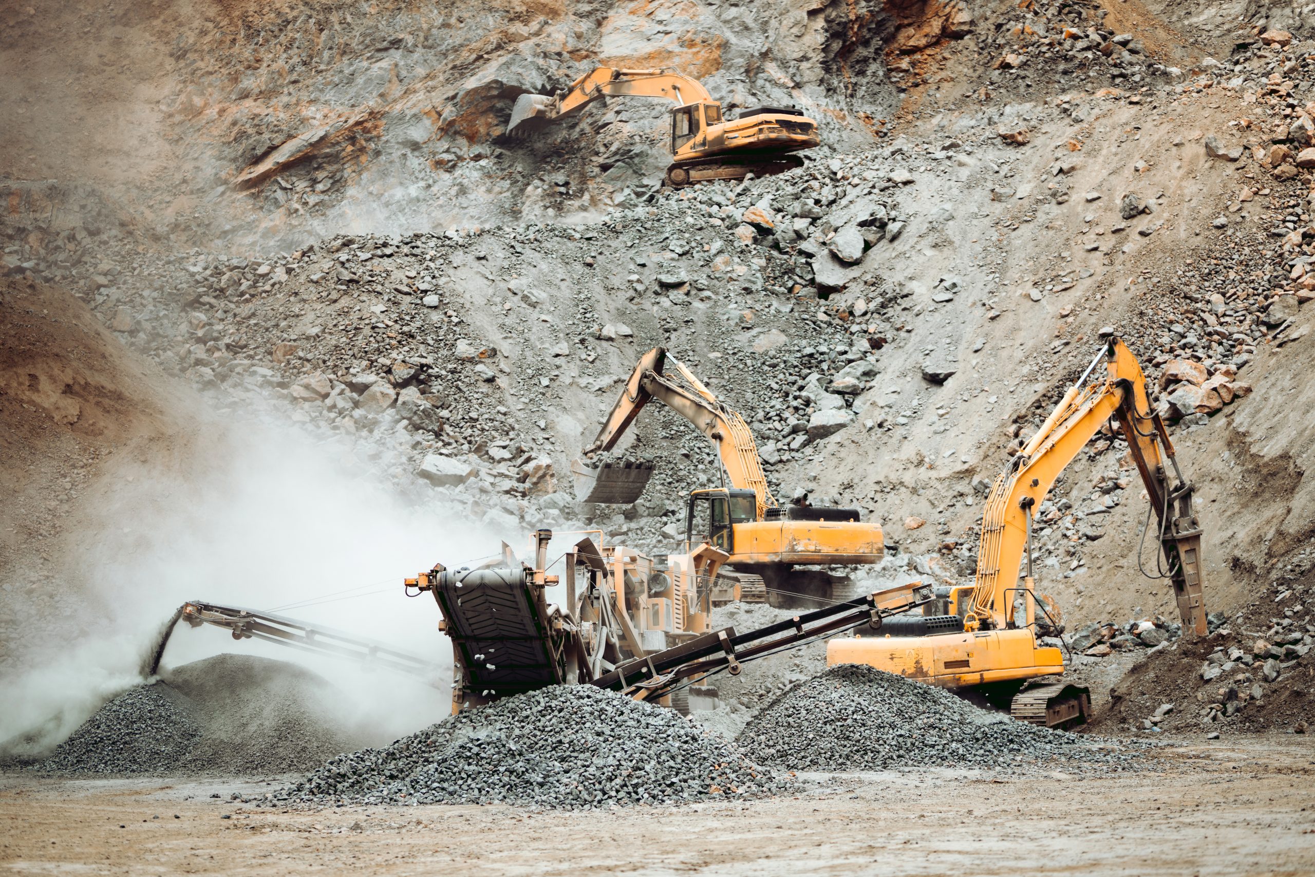 Heavy duty machinery working on quarry. Open pit ore mine details with excavator and bulldozer and hydraulic crusher